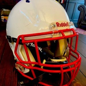 Youth Medium Riddell Football helmet with red face mask and chinstrap included.